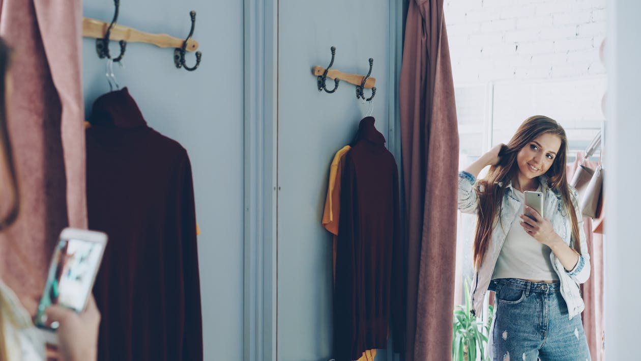 Woman using AI smart mirror for colour blocking outfit styling recommendations
