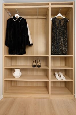 Minimalist wardrobe displaying elegant dresses and heels neatly arranged