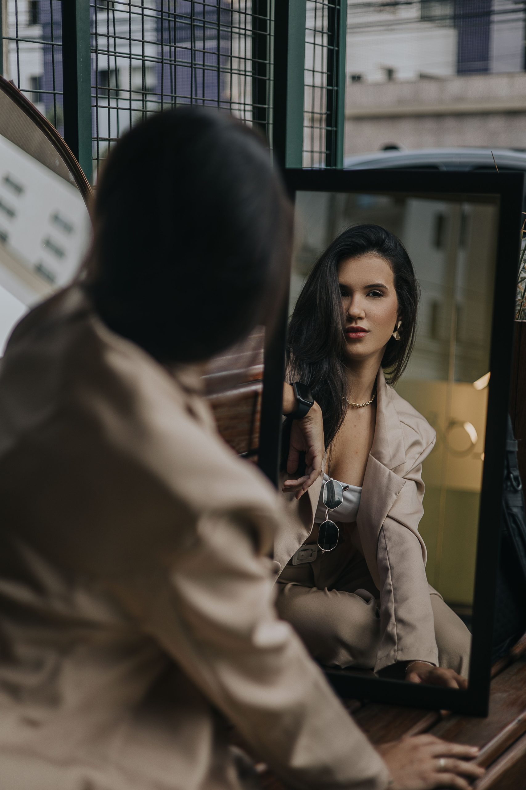 Woman checking her outfit reflection in a smart mirror — AI weekly wardrobe scheduling made simple