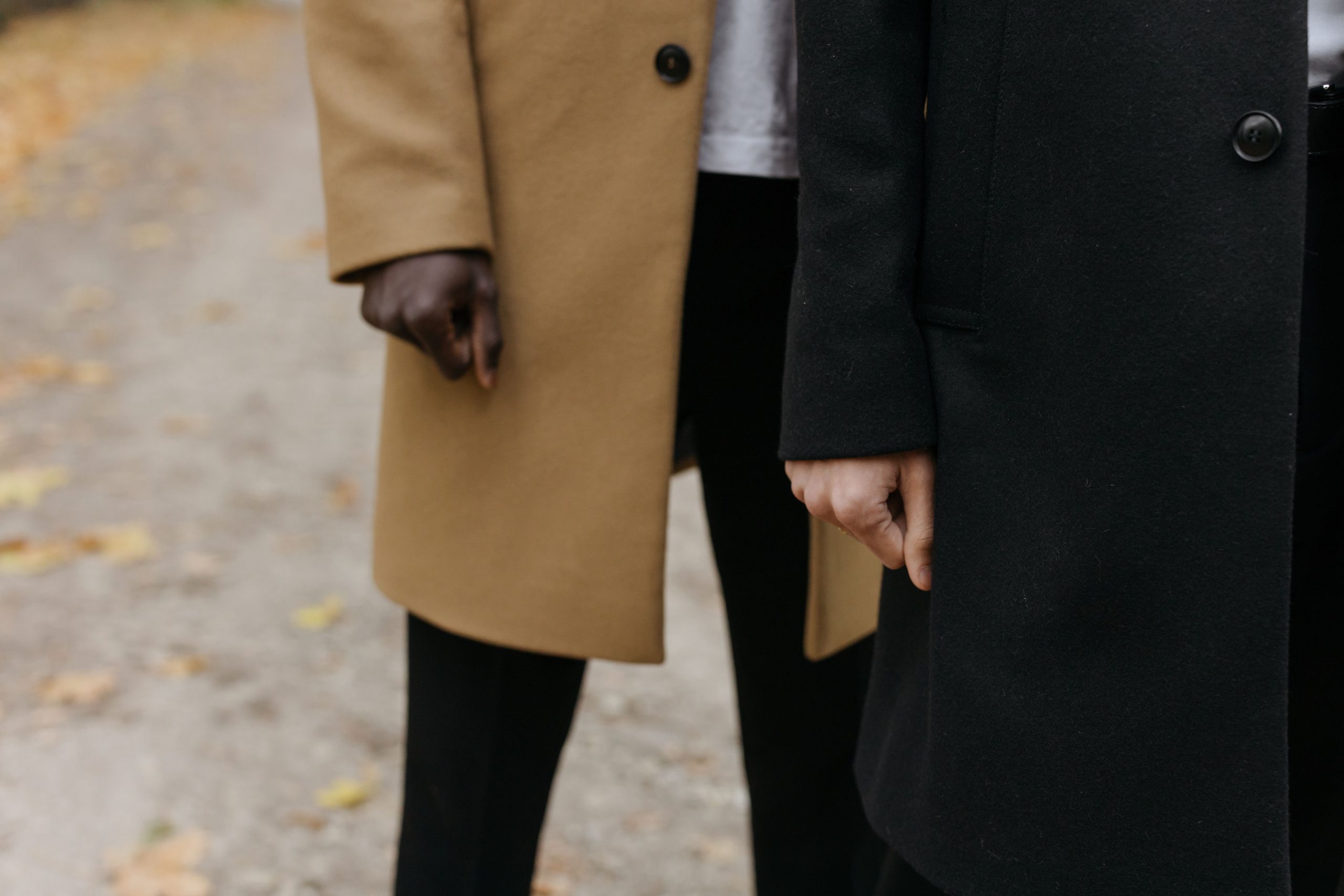 Elegant woman in a tailored coat walking confidently on a city street